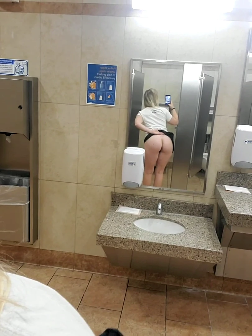 Showing my off my butt plug in a public restroom.